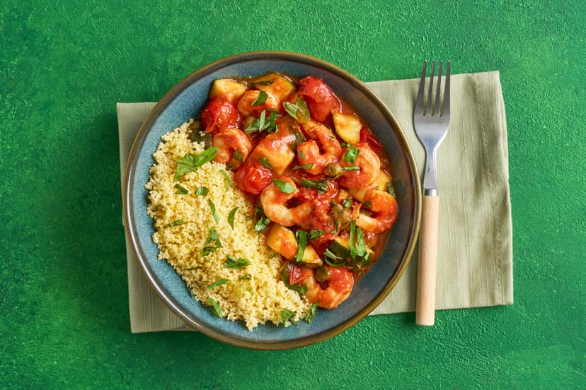 Dinner in as little as 20 minutes? Yes please! This simple dish is packed with the flavours of the Med – prawns, courgettes and tomatoes are lightly cooked in a garlicky tomato sauce, fragrant with lemon, basil and capers, and served on couscous to soak up every last delicious drop.